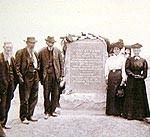 Three Men and Two Women Standing in Frnot of the Town of Platteville Sign